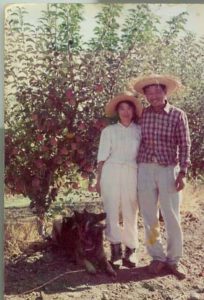 Mr and Mrs Ha in the Orchard Wearing Straw Hats